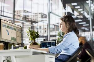 General manager engaged in budget analysis and strategy development at the office, achieving objectives for enterprise growth. Woman managing analytics to accomplish business goals. photo