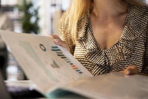 Executive assistant working on document preparation and report writing at her desk, planning business strategy for company development. Achieving organizational goals. Close up. photo