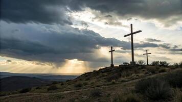 Three crosses stand on a hill under a dramatic sky with sun rays shining through the clouds video