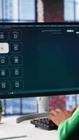 Vertical Computer screen displays digital visuals generated through AI. Young person uses software combining data and machine learning, text prompts to design graphics at home office. Camera A. video