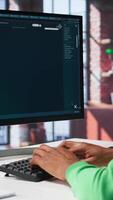 Vertical Computer screen displays digital visuals generated through AI. Young person uses software combining data and machine learning, text prompts to design graphics at home office. Camera B. video