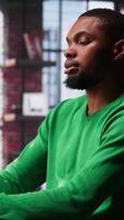 Vertical African american male teleworker completing spreadsheets on laptop, entering numerical data into cells and calculating totals. Guy using spreadsheet software functions. Camera A. video