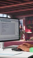Vertical Tech savvy black engineer developing secure online program at home. Surrounded by binary data, freelancer works on interface design, script optimizations and network systems. Camera B. video