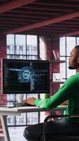 Vertical African american technician writes code on AI brain neural network for machine learning, doing maintenance and debugging the software systems. IT expert uses programming language. Camera A. video