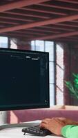 Vertical African American person uses AI chatbot to generate a montage at home office, deep learning models and cloud technology for a personalized project, text to . Camera B. video