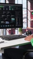 Vertical African american software developer does visual coding and creating software, implementing algorithms. IT expert at home working with notes tree and code language, app performance. Camera B. video