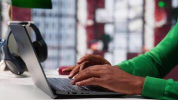 African american teleworker typing ideas to create a vision board on laptop, writing down his dreams and goals aligned with the company objectives. Remote worker connected from his home. Camera A. video