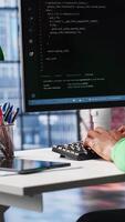 Vertical African american software developer does visual coding and creating software, implementing algorithms. IT expert at home working with notes tree and code language, app performance. Camera A. video