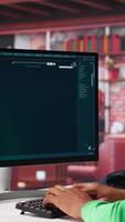 Vertical Black graphic designer working in loft with AI image generator software. Digital screen displaying visuals created through machine learning and cloud computing, . Camera A. video