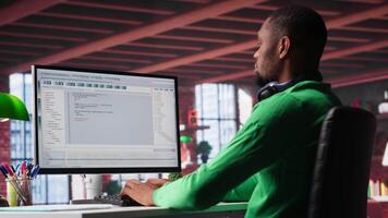 Freelance developer writing code in a modern programming language. Young man analyzes big data, algorithms and optimizing performance while using binary code at home office. Camera A. video