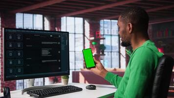 Black guy interacting with intelligent AI chatbot on pc next to copy space screen, using smart innovative system. Machine learning enhances efficiency through advanced algorithms. Camera B. video