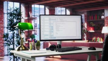 Empty desktop monitor used for software development and coding in a luxurious loft apartment. Modern workstation or in a stylish studio supports tech performance and big data systems. video