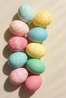 Pastel decorated easter eggs arranged in vertical flatlay with soft shadows on neutral background showcasing festive spring celebration and modern seasonal design concept photo