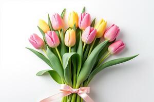 Tulip bouquet with pink and yellow flowers tied with satin ribbon on white background in floral flatlay style showing fresh botanical spring design and natural elegance photo