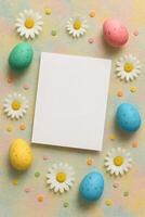 Charming invitation template with Easter eggs, colorful dots, and daisies arranged around a blank card, perfect for personalized messages. photo