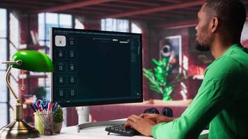 Black guy using text to image AI chat software at his modern loft. Digital screen shows generative content via neural networks, enhancing predictive models and visualized data. Camera A. video