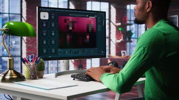African American IT expert using AI technology to generate realistic images from text prompts. Young adult engaging with artificial intelligence tools online, text to image. Camera B. video