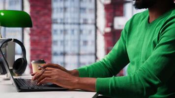 Young remote worker being pensive thinking about new ideas to make money, using his creativity and innovation for development. African american guy looking for new smart ideas. Camera A. video