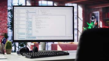 Home office with PC running terminal window for programming code. Designed for IT professionals, the space offers comfort for working on user interface, debugging and algorithm scripts. video