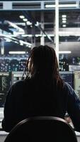 Vertical Irked data center IT expert smashing desk, upset by malfunctioning gear while using node tree software. Mad server hub engineer disgruntled by errors, using glitching AI visualization tech, camera A video