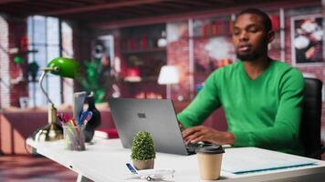 African american employee seated at home office using his pc, checking emails and answering messages in inbox. Remote worker managing electronic correspondence, tech savvy. Camera A. video