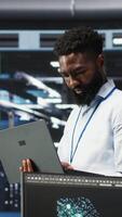 Vertical Data center engineer doing node tree programming to optimize resource allocation. Server farm specialist using predictive AI visualization systems for maintenance planning, camera B video