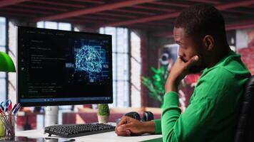 African american engineer coding a neural network AI brain model for machine learning and deep learning, solving IT support tasks on pc. Debugging software and checking for errors. Camera A. video