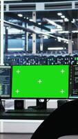 Vertical Chroma key computer displays in data center workplace used for managing supercomputers hardware energy consumption. Green screen PC used for automation in server hub workplace video