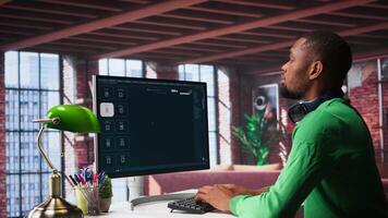 African American person uses AI chatbot to generate a montage at home office, deep learning models and cloud technology for a personalized project, text to . Camera B. video