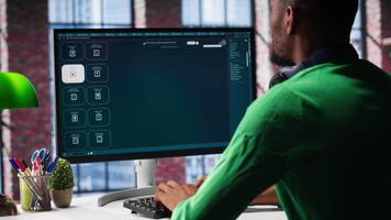 Computer screen displays digital visuals generated through AI. Young person uses software combining data and machine learning, text prompts to design graphics at home office. Camera A. video