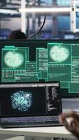 Vertical Man with paraplegia in server hub trying to protect hardware from hacker attack stealing sensitive information. Data center specialist in wheelchair fighting virus during security breach, camera B video