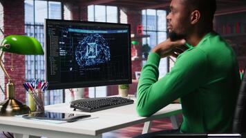 African american IT expert doing maintenance on artificial intelligence neural networks, writing code on terminal window. Male tech support engineer doing checkup on AI systems. Camera B. video