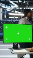 Vertical Data center admin using AI node tree software on isolated screen PC to minimize system downtime. Server hub worker uses artificial intelligence visual programming tool on chroma key computer, camera B video