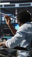 Vertical Man in wheelchair dissatisfied with server farm AI analytics metrics. Data center admin with paraplegia frustrated by glitches while automating tasks using node tree programming tool, camera A video