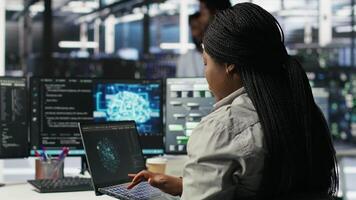 Data center admin uses AI technology on laptop for machine learning workloads. Server hub worker using artificial intelligence on notebook to perform demanding computing tasks, camera B video