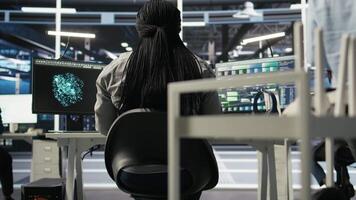 Server farm IT specialist using PC to apply artificial intelligence technology minimizing system downtime. Engineer using computer to develop and deploy AI solutions optimizing equipment, camera A video