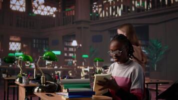 African american girl does bachelor paper research for citations and other information, using the database at the campus library. Intelligent student working on her diploma. Camera B. video