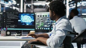Man in wheelchair dissatisfied with server farm AI analytics metrics. Data center admin with paraplegia frustrated by glitches while automating tasks using node tree programming tool, camera B video