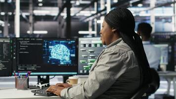 Data center employee deploying AI solutions optimizing equipment. Server farm software developer applying artificial intelligence technology minimizing infrastructure downtime, camera B video