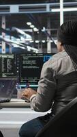 Vertical Data center coworkers doing brainstorming, using artificial intelligence machine learning models to configure equipment. IT experts cooperating in server farm, working on optimizing systems, camera A video