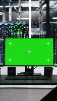 Vertical Green screen computers in data center managing energy consumption using node tree software. Mockup PC systems automating monitoring processes in server room using visual programming tools video