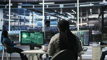 Server farm engineering team collaborating to protect against data theft during cyberattack. Data center coworkers rushing to safeguard infrastructure systems during security breach, camera A video