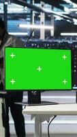 Vertical Data center worker with paraplegia using green screen PC to apply node tree programming. Server hub admin with disability uses visual programming on mockup computer to identify data patterns, camera B video