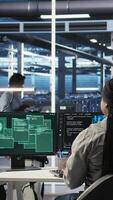 Vertical Server hub coworkers react to security breach after unauthorized access bypassing firewall compromising data. Employees initiate emergency response protocols after cybersecurity alert, camera A video