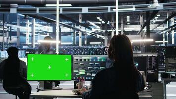 Server farm engineer using node tree systems on green screen PC to categorize unstructured data. Data center IT expert uses visual programming software on mockup chroma key computer, camera A video