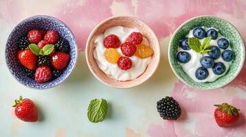 Delicious yogurt bowls topped with fresh berries and mint on a colorful pastel background photo