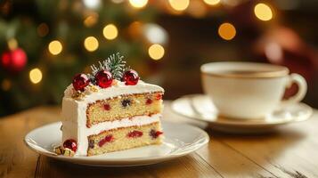 A piece of cake on a plate next to a cup of coffee photo