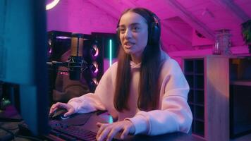 Close up beautiful girl woman female gamer emotional happy enjoying cyberpunk game playing internet online computer talking broadcast streaming communicate with microphone futuristic neon room video