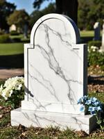 A marble tombstone with flowers in front of it photo