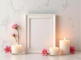 White frame with pink flowers and candles on a marble counter photo
